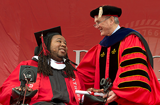 President Barchi handing Eric LeGrand his Diploma